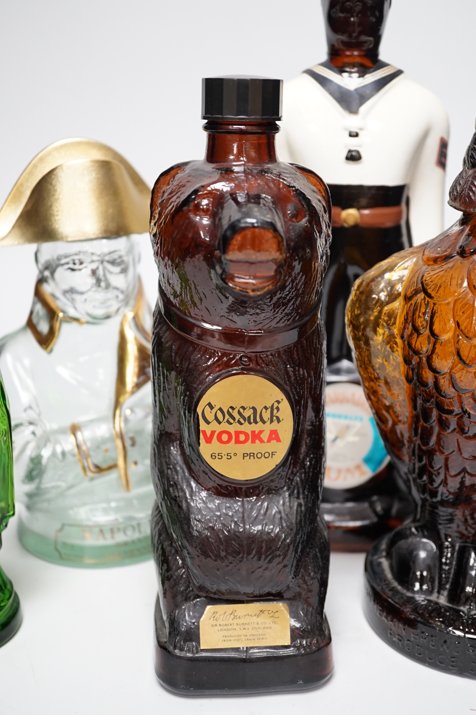 Five novelty empty flasks including Napoleon brandy and Cossack vodka